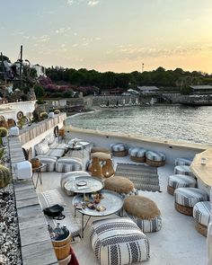 an outdoor seating area next to the water