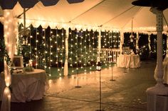 the inside of a tent decorated with lights