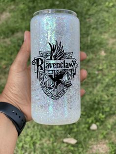 the ravenclaw glitter tumbler is being held by someone