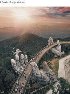 an aerial view of the golden bridge, vietnam with people walking up and down it