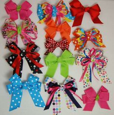 many different colored bows on a white surface with polka dots and circles in the middle