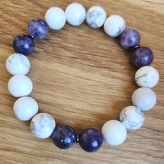 a bracelet with white and purple marble beads