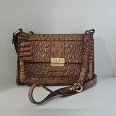 Brahmin Brown /Tan Crocodile Leather Crossbody Bag ,Top Zipper Closure, Interior Zipper Pocket, Front Flap Turnluck Pocket, Distressed Brass Hardware, Back Slip Pocket, Adjustable Strap. Bag In Good Condition Just Some Stains Inside And Light Discoloration At The Corners. Size: 11"W7.5"H 2.8"D Drop Strap: 25" Designer Brown Bag With Crocodile Pattern, Cognac Leather Bag With Crocodile Pattern, Leather Bags With Crocodile Pattern In Cognac, Designer Brown Shoulder Bag With Crocodile Pattern, Designer Brown Crocodile Pattern Shoulder Bag, Adjustable Strap Bag, Brahmin Bags, Brahmin Handbags, Strap Bag