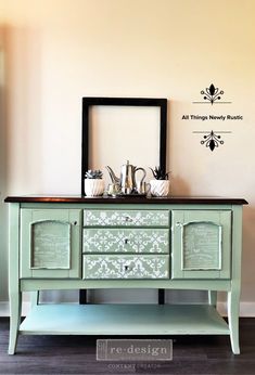 an old dresser painted green and decorated with silverware on it's sideboard