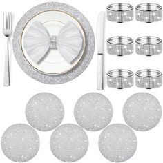 a table setting with silver glitter plates and napkins