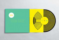 two yellow and green records sitting next to each other on top of a white surface