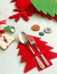 spoon, fork and christmas tree made out of felt on white table with other items