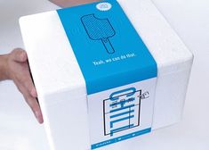 a person holding a box with an ice cream on it