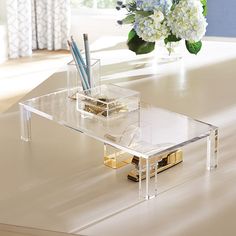 a clear table with some flowers in it