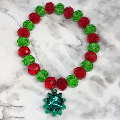 This traditionally colored, OOAK Christmas 🎄 stretch bracelet is made with red & green faceted crystal rondelles and finished off with a beautiful emerald green bow. It's the perfect, festive sparkly little Christmas bracelet.  PLEASE REFER TO LAST PIC WHEN ORDERING YOUR BRACELET SIZE.  Stretch bracelet is made with 100% polyester stretch cord, not wire. *The little bow is made with nickel free and lead free lightweight alloy. Cheap Beaded Bracelets For Christmas, Christmas Gift Jewelry With Faceted Beads, Green Bracelets For Christmas Party, Green Christmas Gift Bracelets, Christmas Green Beaded Bracelets, Green Christmas Bracelet Gift, Green Bracelets For Christmas Gift, Green Christmas Festive Bracelets, Red Stretch Bracelet For Christmas