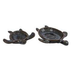 two small turtle shaped dishes sitting on top of each other