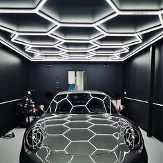 a car parked in a garage with lights on the ceiling