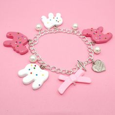 This frosted circus animal cookie bracelet is so whimsical, girly and fun, a perfect gift for any woman who loves cute charm jewelry, kawaii or pink. Handmade, the resin pendants are so realistic you may think they are real cookies! The cookie charms are on the larger side so this is definitely a statement piece. Available in your choice of gold or Silver finish.Details & Measurements: Pendants are hand-painted resin Pendants are 1.5" in size (3.75cm) Bracelet is 7.5" long (18.75 cm) Available in gold or silver finish Glass Pearls Baby Pink Bow Bead Finished with a Fatally Feminine Designs heart charm and toggle clasp Handmade More Animal Cookie Jewelry available, just search "animal Cookie"Shipping & Gift Options: item is handmade to order and will take around 1 week to process before shi Cookie Jewelry, Baby Pink Bow, Chunky Charm Bracelet, Circus Animal Cookie, Jewelry Kawaii, Charm Bracelet Gold, Animal Cookie, Pink Gift Box, Resin Pendants