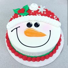 a frosted cake with a snowman face on it