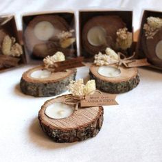 small wood slices with candles in them on a table