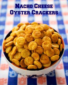 a bowl filled with cheesy oyster crackers on top of a checkered table cloth