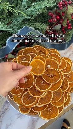 someone is placing slices of oranges on top of each other in a platter