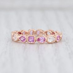 Gem: Natural Sapphires - 2.54 Total Carats, Oval / Pear / Marquise Brilliant, White and Pink Color, Heat TreatmentMetal: 14k Rose GoldWeight: 2.4 Grams Stamps: 14k bkc BKBand Width: 3.7 mm Rise Above Finger: 3 mmThis ring is a size 6 1/2. If you need your ring sized please click HERE and purchase the appropriate fee amount along with your ring. Once a ring is resized, we guarantee the work but we are unable to offer a refund on the sizing. Please contact for additional sizing options. Each piece Pink Wedding Rings, Color Rings, White Sapphire Ring, Pink Sapphire Ring, Pink Accessories, Cluster Rings, Rise Above, Purple Band, White Gold Band