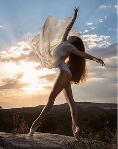 a woman is dancing on top of a rock with the words let your light shine each day