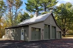 a two car garage sits in front of some trees