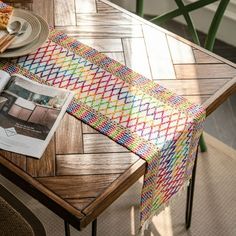 a table with a magazine, plate and napkin on it