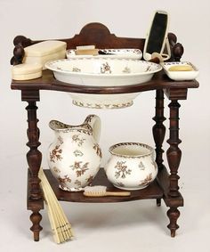 a wooden table topped with bowls and vases next to a cell phone on top of it