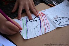 a child's hand on top of a piece of paper