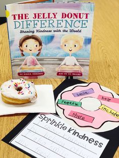 the jelly donut reference book is next to a doughnut with sprinkles on it