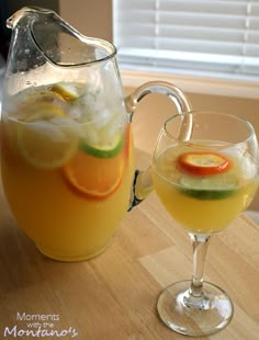 two glasses filled with drinks sitting on top of a table