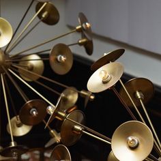 an array of brass colored lights hanging from the ceiling