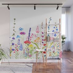 a room with flowers painted on the wall and wooden ladders in front of it