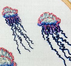 two jellyfishs are in the water on this embroidery pattern