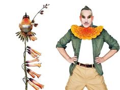 a man standing next to a fake flower