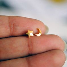 Tiny little stars and moons for everyday delights! Handcrafted in 14K gold, these trinkets can be worn as nose pins as well as ear studs. * Gold - 14K Solid Yellow Gold * Wire - 20 gauge * Post length from back of stone to bend : 4-5 mm (approx.) * Nose Stud Dimensions (approximate) : 5-7 mm * Style : C/L Wire - Diamond Nose Stud: https://www.etsy.com/listing/263702395/solitaire-nose-stud-diamond-nose-pin-14k?ref=shop_home_active_7 - Rough Emerald Nose Pins : https://www.etsy.com/in-en/listing/5 Minimalist Gold Crescent Cartilage Earrings, Minimalist Gold Cartilage Earrings With Moon Charm, Gold Minimalist Cartilage Earrings With Moon Charm, Dainty Yellow Gold Earrings With Moon Charm, Gold Dainty Cartilage Earrings With Star Charm, Gold Dainty Star Cartilage Earrings, Gold Star-shaped Dainty Cartilage Earrings, Dainty Gold Cartilage Earrings With Star Charm, Dainty Gold Star Cartilage Earrings