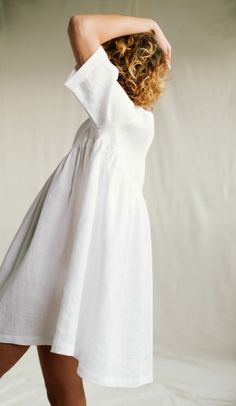 Beautiful deep V-neckline smock dress in white linen. Easy to wear as a dress or to layer as a tunic. - Handmade in our studio from 100% organic linen - Loose fit - V-neckline - Elbow-length folded sleeves - Ruffled skirt - Hidden side seam pockets Folded Sleeves, How To Fold Sleeves, White Linen Dresses, Raspberry Color, Ruffled Skirt, Organic Linens, Smock Dress, Linen Dresses, White Style