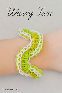 a hand with a green and white crochet bracelet on it's arm