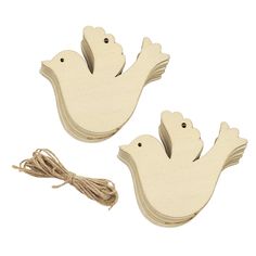 two wooden doves with string attached to them