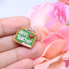 A cute, simple chalkboard polymer clay charm. This little charm has 'Best Teacher' spelled out in clay, with a tiny heart next to it. The perfect, little gift for a special teacher in your life. Handmade from polymer clay. Clay Teacher Gifts, Food Charms, Dog Charms, Polymer Clay Charms, White Clay, Clay Charms, Best Teacher, Handmade Accessories, Christmas Shopping