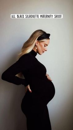 a pregnant woman in a black dress poses for the camera with her hands on her hips