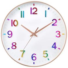 a white clock with multi - colored numbers on it's face is shown against a white background