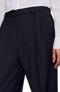 Straight-leg, oversize wool trousers with ironed creases, embellished with fine stripes, side pockets and welt pockets on the back.           These trousers match the jacket  and tie Sandro Women's wool trousers Ironed creases Stripes Belt loops The model is 5'8 tall and wears a size 4 Pinstripe Tapered Leg Pants For Formal Occasions, Pinstripe Tapered Leg Dress Pants For Formal Occasions, Striped Dress Pants With Welt Pockets For Work, Tailored Pinstripe Pants For Formal Occasions, Wool Pantsuit With Welt Pockets For Tailoring, Pinstripe Dress Pants With Welt Pockets For Formal Occasions, Formal Striped Bottoms For Fall, Striped Bottoms For Formal Occasions In Fall, Formal Striped Pants With Welt Pockets