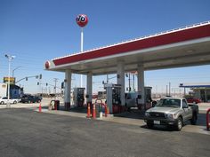 a gas station with cars and trucks at it