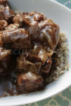 a white bowl filled with meat and rice