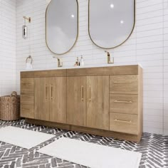 a bathroom with two sinks and three mirrors on the wall above them is tiled flooring