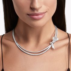 This enchanting white gold necklace set with radiant pavé diamonds from the Tilda’s Bow collection is a new interpretation of the bow motif, which has had an enduring influence on the House of Graff. The seamless, hand-tied effect was achieved through a close collaboration between our design team and master craftsmen, who have created a sculptural, voluminous silhouette set with radiant stones, allowing it to scintillate from every angle. A charming Tilda’s Bow baguette cut and round diamond and Graff Jewelry, Classic Diamond Ring, Diamond Drop Pendant, Diamond Drop Necklace, Diamond Bows, Fine Diamond Jewelry, Bow Necklace, Platinum Jewelry, Bow Jewelry