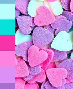 there are many heart shaped candies in the color pink and blue, as well as two different colors