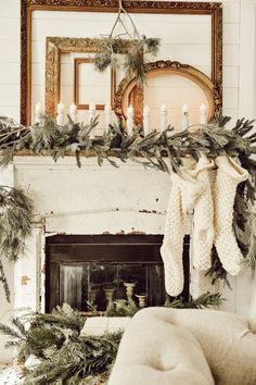 a fireplace with stockings hanging from it's mantle and candles on the mantel