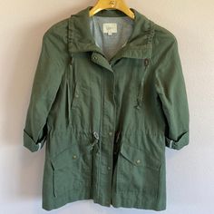 Ann Taylor Loft Olive Green Field Jacket (It's A Little Darker Than The Photo's Show) Nwot Beautiful Condition Size M (It's Very Roomy, Could Fit A Large) Zipper And Snap Closure Drawstring Waist Sleeves Are Folded Up With Sleeve Tabs For A 3/4 Length Or Can Be Worn Down For Full Length Sleeves Also Know As Military Or Utility Jacket Please Feel Free To Send Me Questions Or Additional Picture Requests. Most Of My Items Unless Stated Are Preowned. Please Expect Some Sense Of Wear. All Major Flaws Will Be Noted. My Items Have Been Cleaned, Steamed And/Or Laundered. May Have Detergent Fragrance. If There Is Any Type Of Vintage/Storage Odor I Will Note That As Well. All Items Will Ship Within Green Fall Parka For Workwear, Green Spring Parka With Pockets, Green Cotton Parka For Spring, Spring Green Cotton Parka, Spring Workwear Parka With Pockets, Green Spring Workwear Parka, Green Parka For Spring Workwear, Green Spring Parka For Workwear, Green Spring Parka For Work