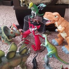 several toy dinosaurs are on the floor next to each other