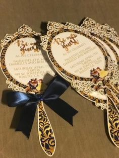 the wedding stationery has been designed to look like an ornate fan with disney characters on it